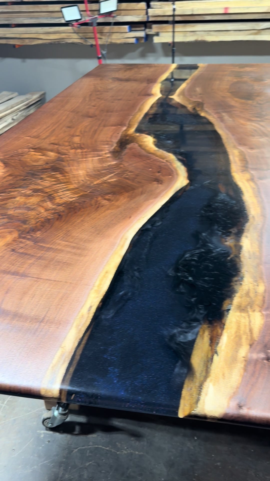 Midnight Sky black walnut river table with a deep blue epoxy river
