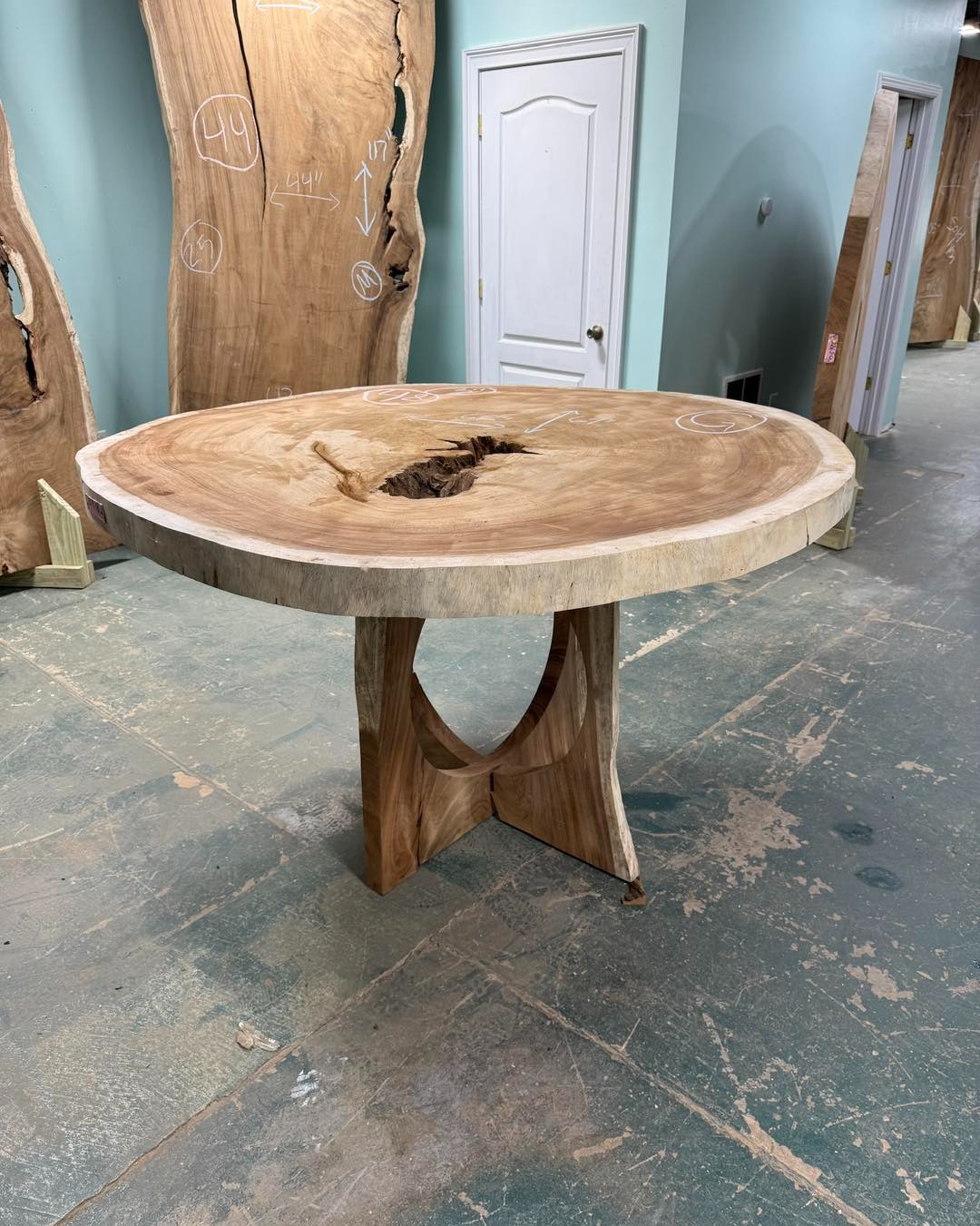 Finished round live-edge wood table on a sculpted wood base, from our Statham, GA shop