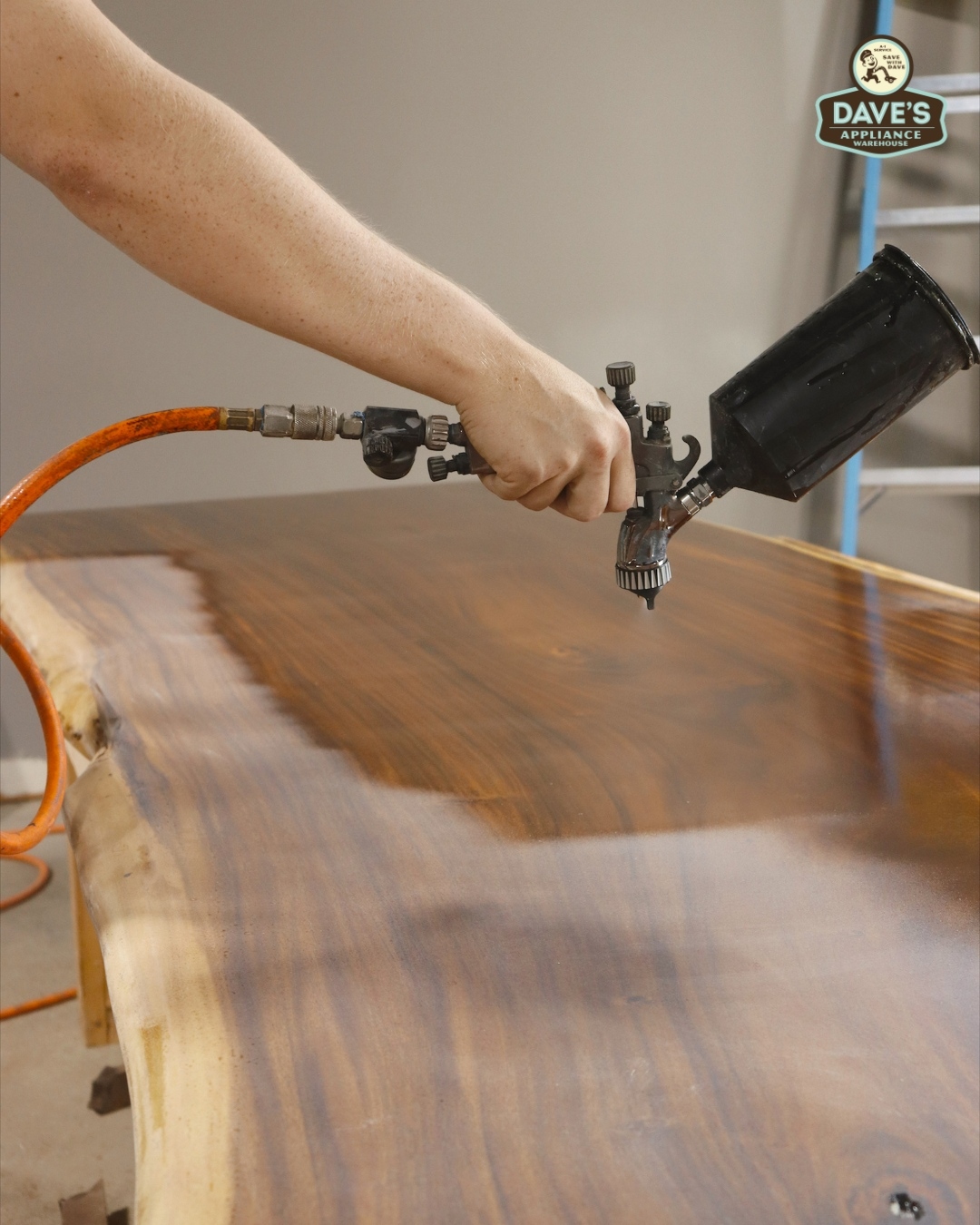 Spray finishing a custom slab tabletop in the Statham workshop