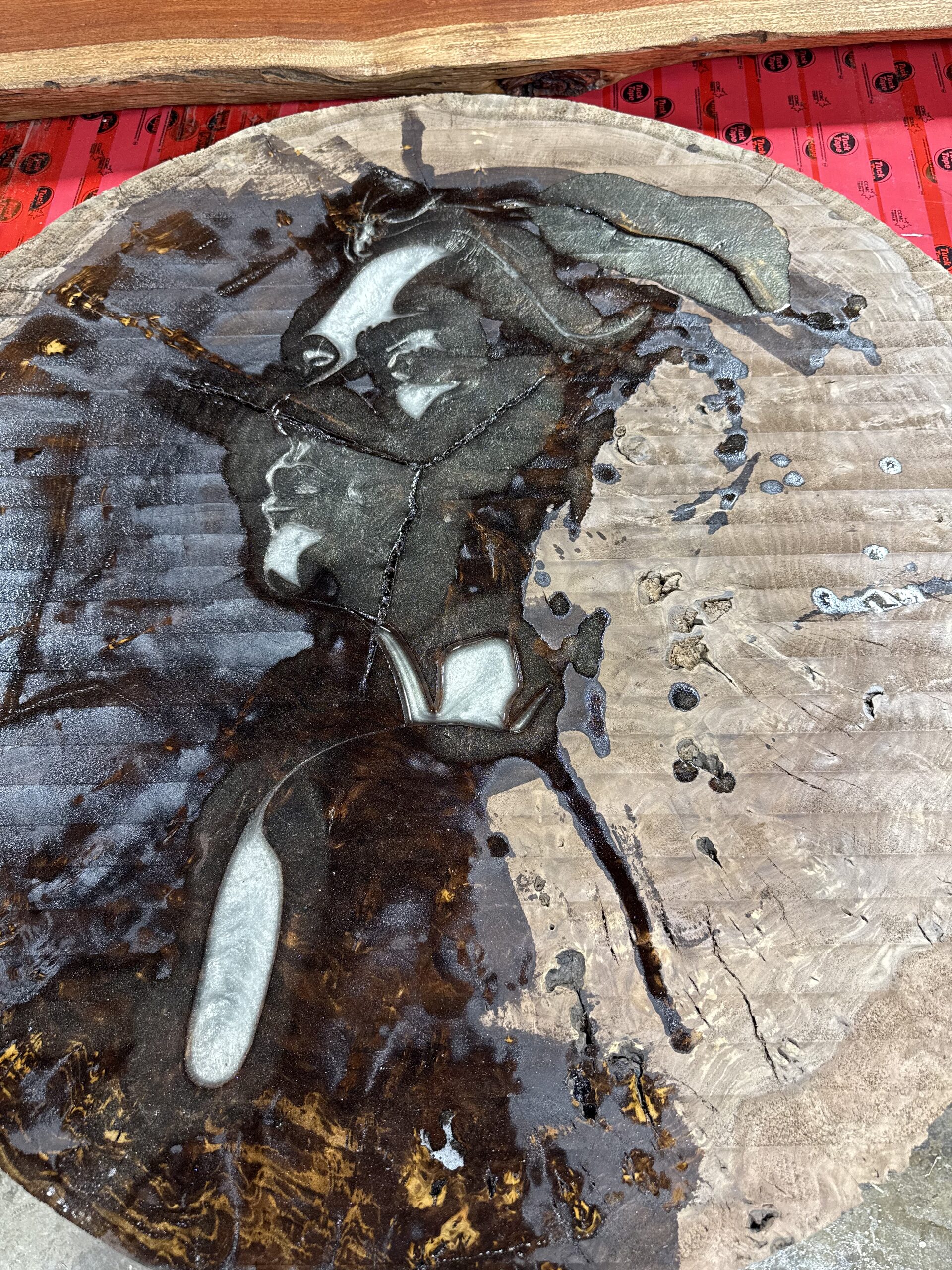Round table top with a frosted resin river around a log-cookie inlay